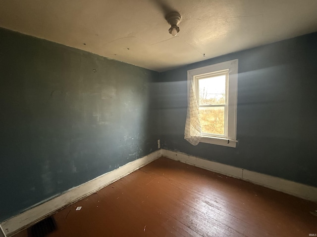 spare room featuring wood-type flooring