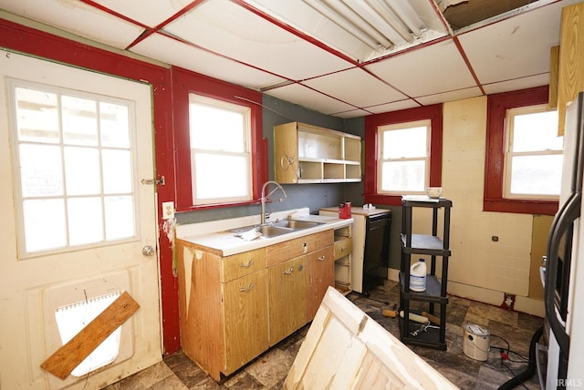 kitchen with a paneled ceiling, fridge, and sink