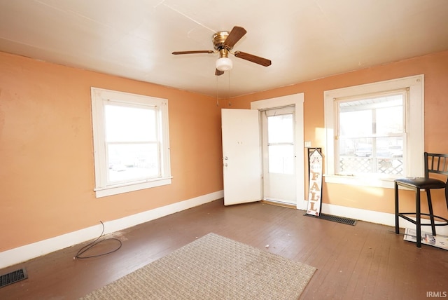 interior space with ceiling fan and dark hardwood / wood-style floors