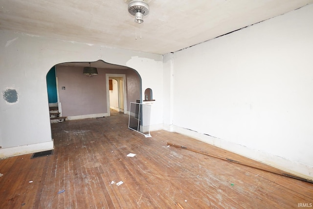 unfurnished room with wood-type flooring