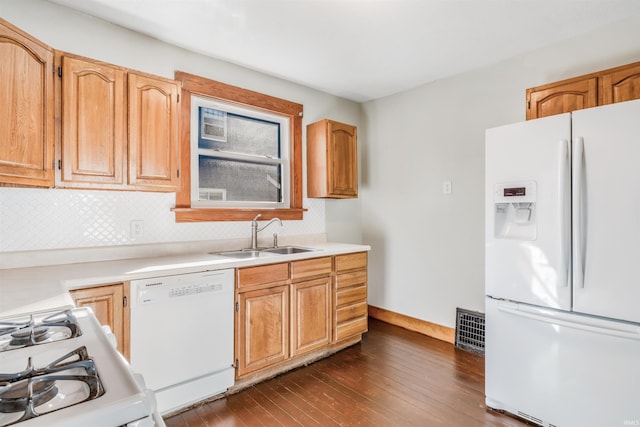 kitchen with dark hardwood / wood-style flooring, white appliances, tasteful backsplash, and sink