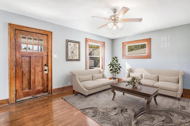 living room with wood-type flooring and ceiling fan