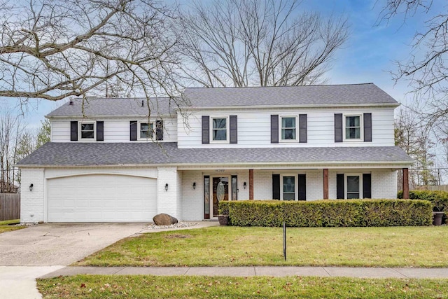 view of front facade with a garage and a front yard