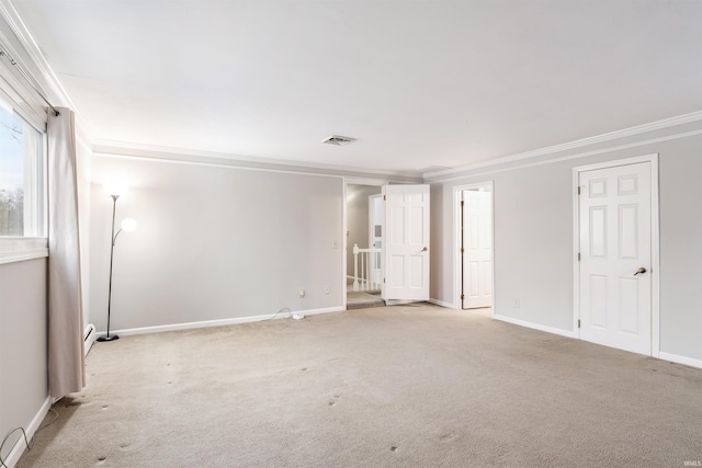 carpeted spare room with ornamental molding