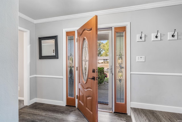 entrance foyer with dark hardwood / wood-style floors and crown molding