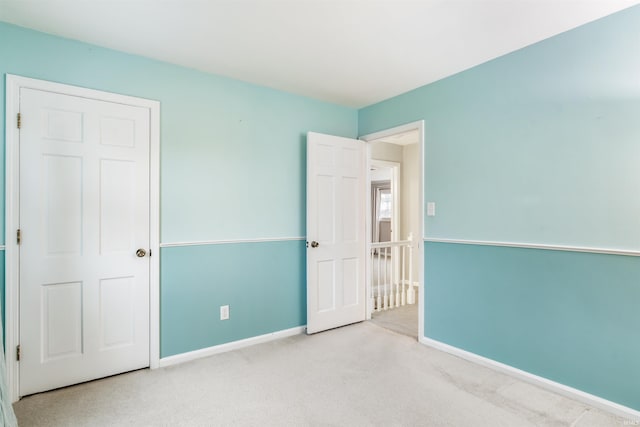 unfurnished bedroom with light colored carpet