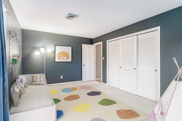 bedroom with a closet and light colored carpet