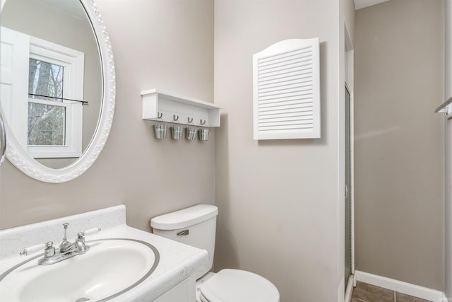 bathroom with vanity, toilet, and a shower with shower door