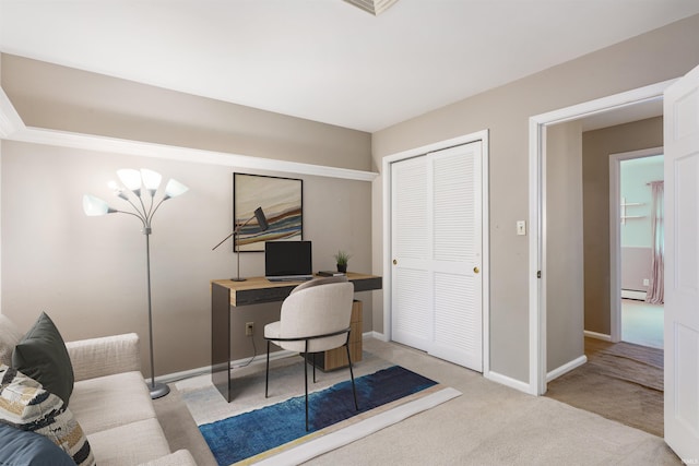 carpeted office featuring a baseboard radiator