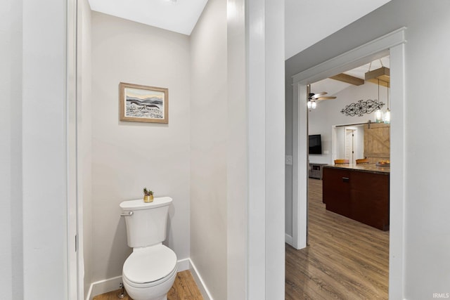 bathroom with vanity, ceiling fan, wood-type flooring, beamed ceiling, and toilet