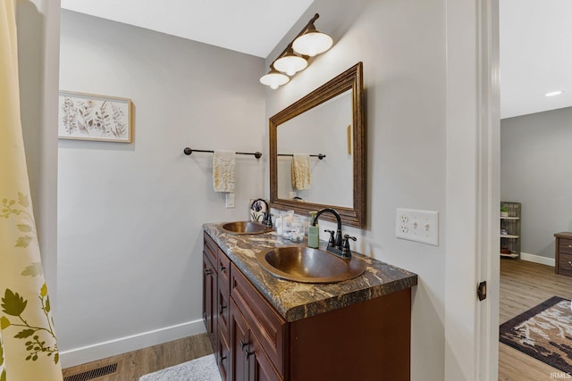 bathroom featuring vanity and wood-type flooring