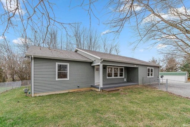 rear view of property with a lawn and a deck