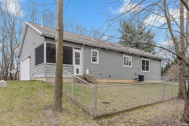 exterior space with central AC and a front lawn