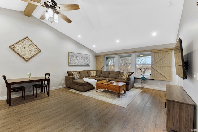 living room with lofted ceiling with beams, ceiling fan, and wood-type flooring