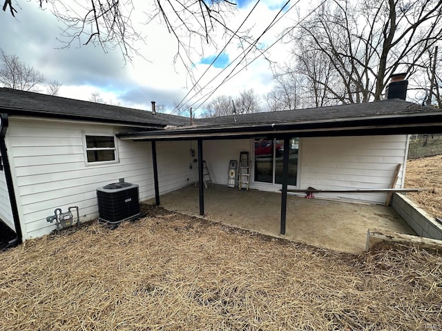 back of property featuring cooling unit and a patio