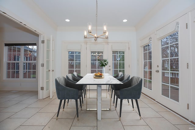 dining room featuring a chandelier, light tile patterned floors, crown molding, and french doors