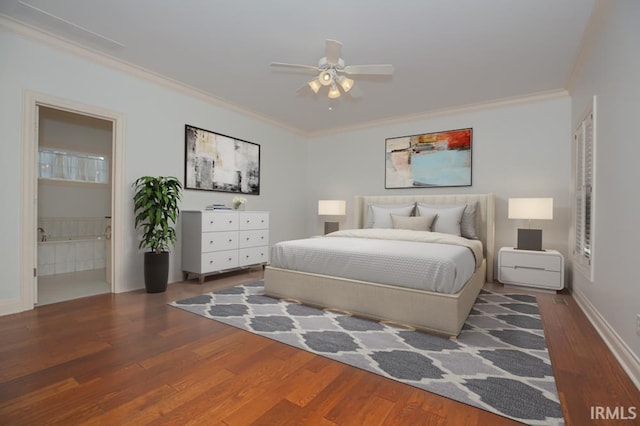 bedroom featuring dark wood-type flooring, ensuite bath, ceiling fan, and ornamental molding