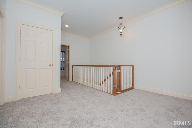 carpeted spare room featuring ornamental molding