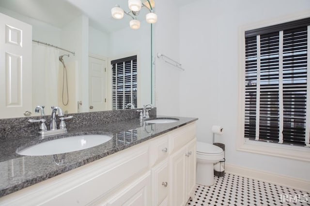 bathroom featuring vanity, a shower with shower curtain, a notable chandelier, and toilet