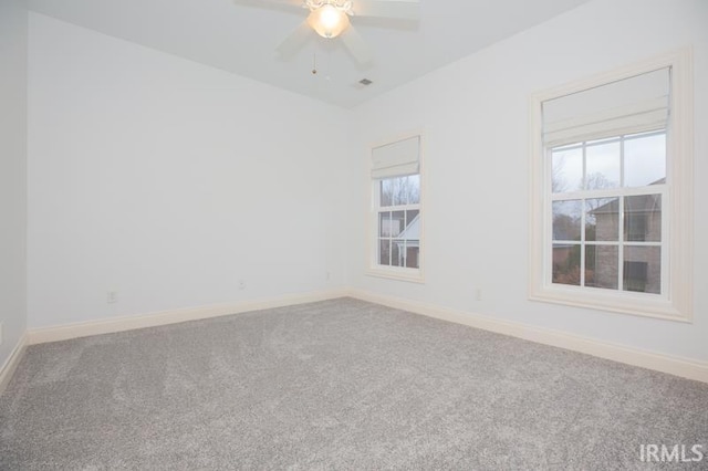 empty room featuring carpet floors and ceiling fan