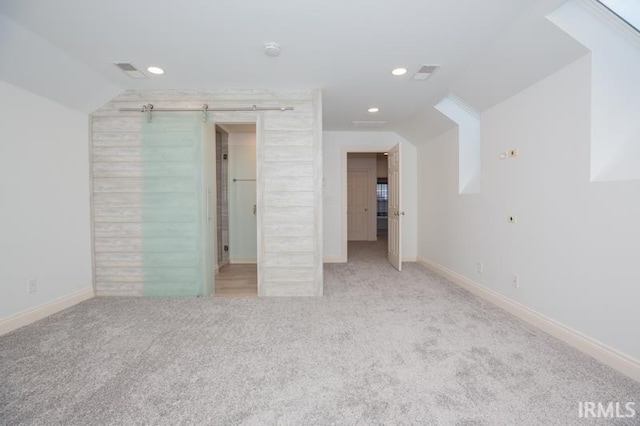 unfurnished bedroom featuring light carpet and vaulted ceiling