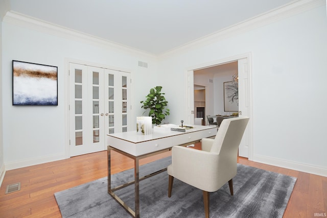 office area with wood-type flooring and ornamental molding