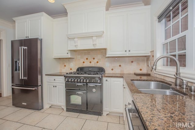 kitchen with stone countertops, white cabinetry, sink, and appliances with stainless steel finishes