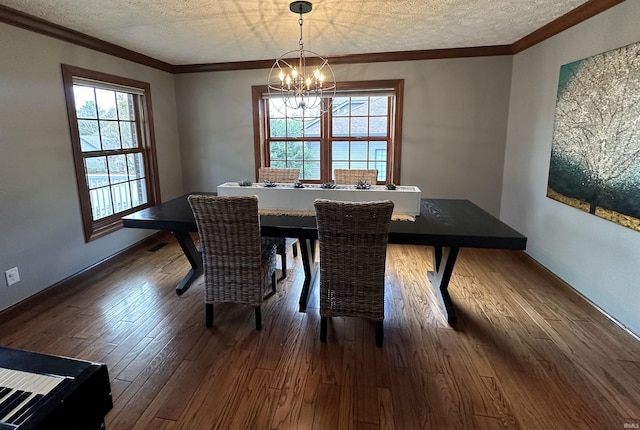 dining space with a healthy amount of sunlight, crown molding, a chandelier, and a textured ceiling