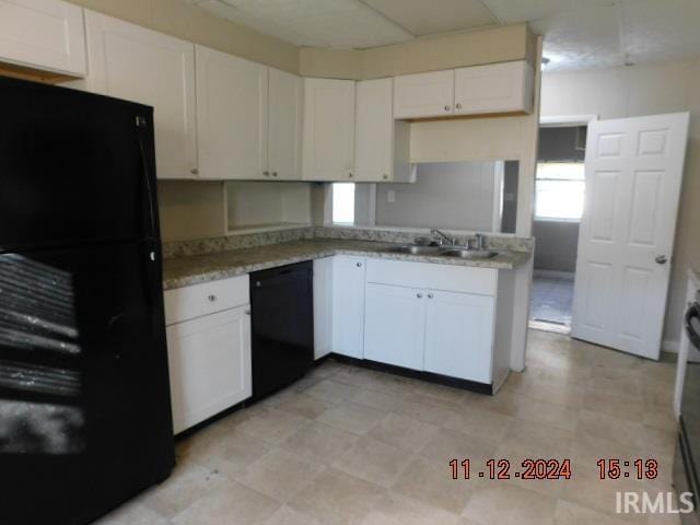 kitchen featuring white cabinets, sink, kitchen peninsula, and black appliances