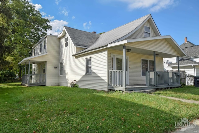 view of front of home with covered porch and a front lawn