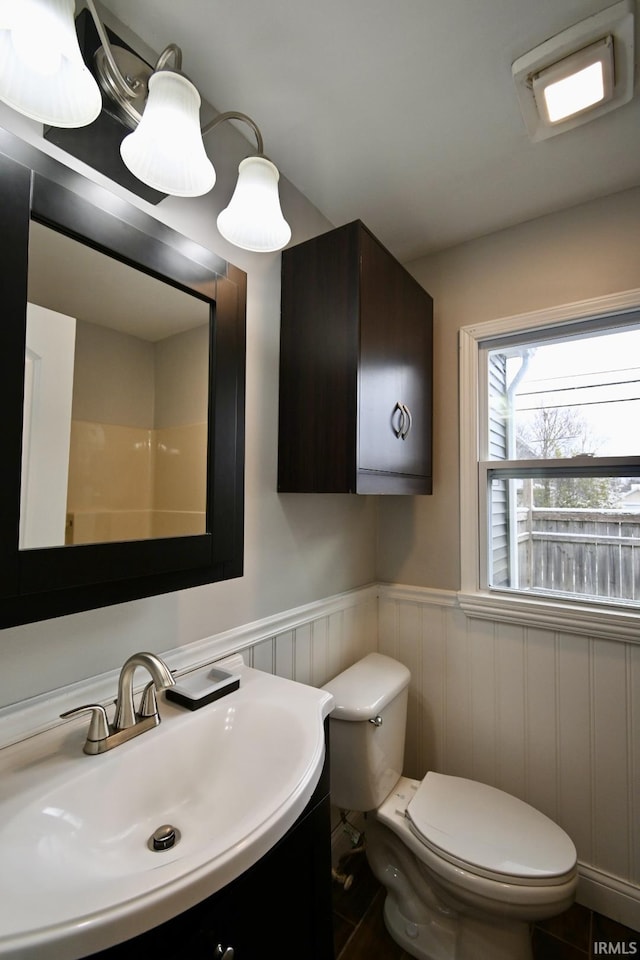 bathroom featuring tile patterned floors, vanity, and toilet