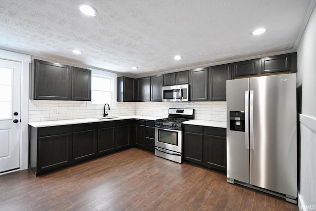 kitchen featuring backsplash, sink, dark hardwood / wood-style floors, and appliances with stainless steel finishes