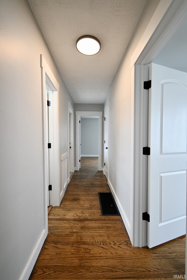 hallway featuring dark wood-type flooring