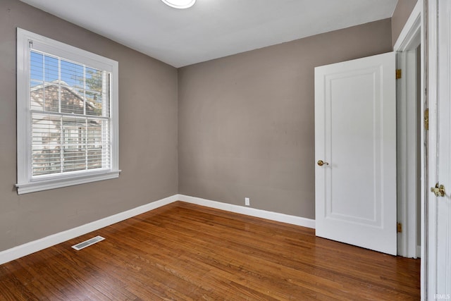 spare room featuring wood-type flooring