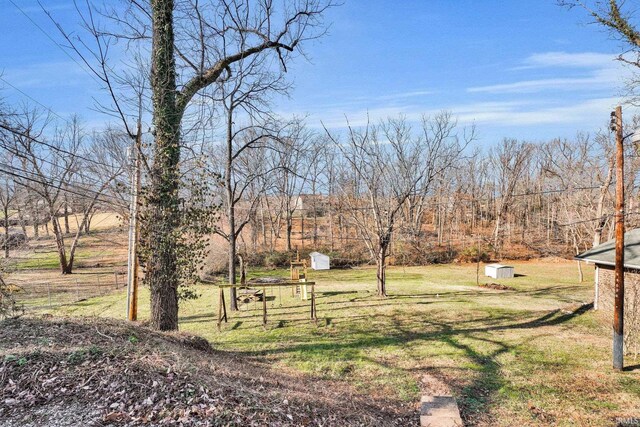 view of yard with a rural view and a shed