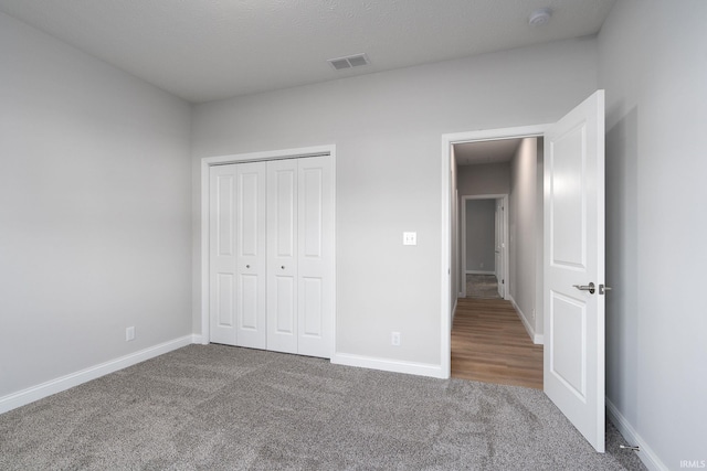 unfurnished bedroom with carpet floors and a closet