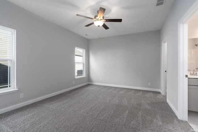 carpeted spare room with ceiling fan