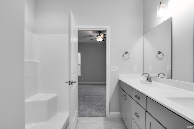 bathroom with tile patterned flooring, ceiling fan, and vanity