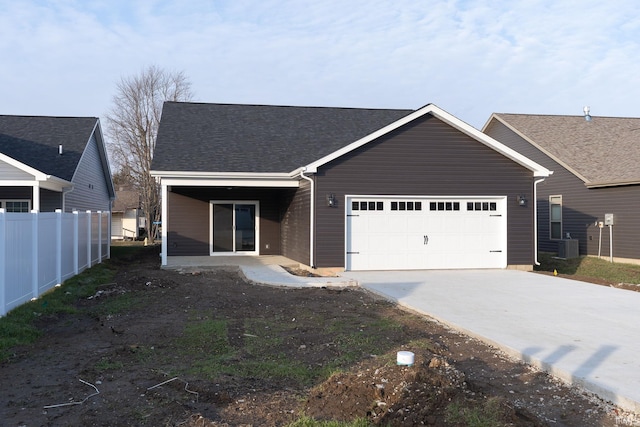 view of front of property with central AC and a garage