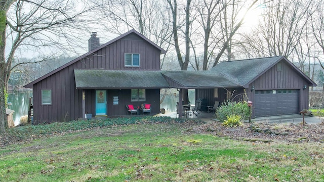 view of front of house with a patio, a garage, and a front lawn