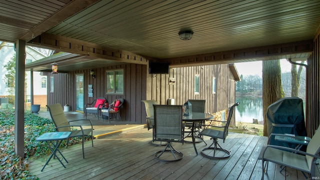 wooden terrace featuring a grill