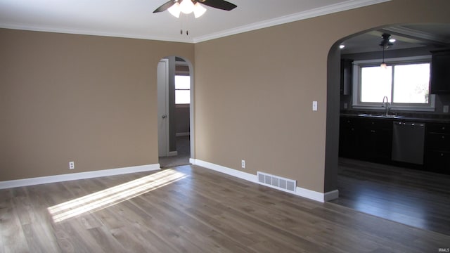 unfurnished room with dark wood-type flooring, ceiling fan, and ornamental molding