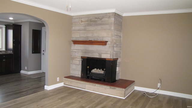 unfurnished living room with ornamental molding and wood-type flooring