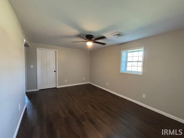 unfurnished room featuring dark hardwood / wood-style floors and ceiling fan