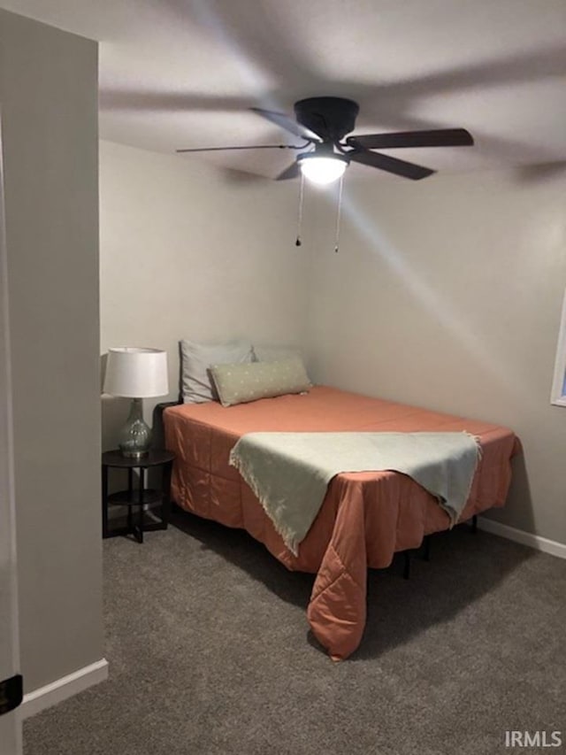 bedroom featuring dark colored carpet and ceiling fan