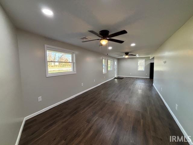 unfurnished room with ceiling fan and dark hardwood / wood-style flooring