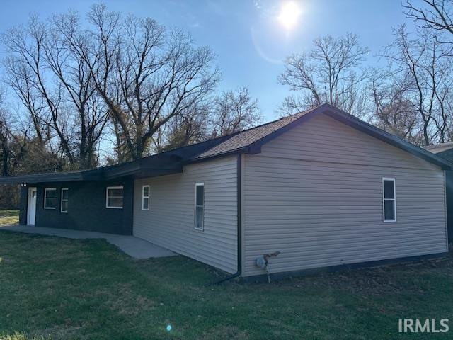 view of property exterior with a lawn