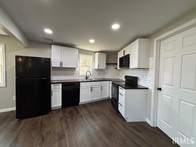 kitchen with black appliances, white cabinets, sink, and dark wood-type flooring