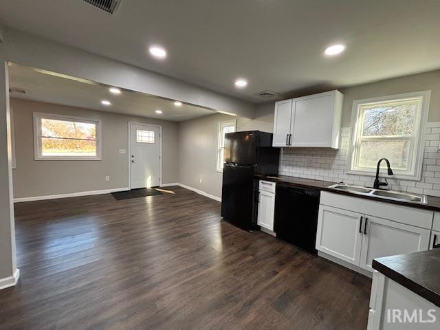 kitchen featuring white cabinetry, sink, dark wood-type flooring, tasteful backsplash, and black appliances