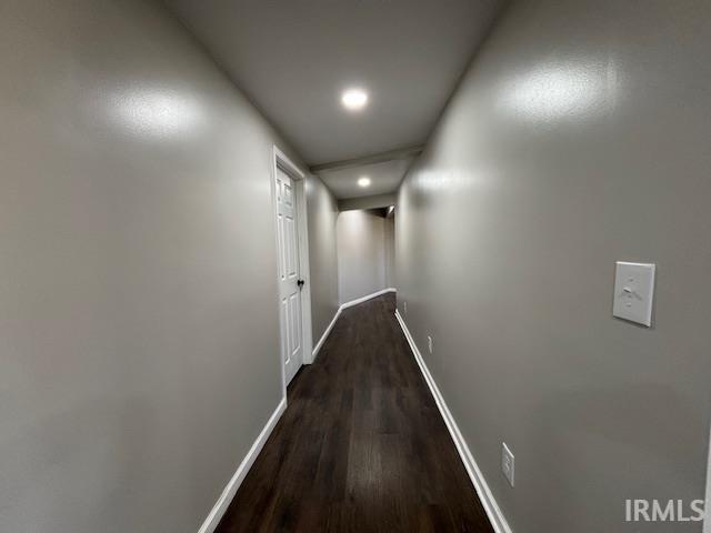 hallway featuring dark hardwood / wood-style flooring